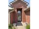 Inviting front entryway featuring a brick archway and a stylish storm door at 5148 Constitution Ct, Columbus, IN 47203