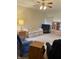Cozy living room with plush carpeting, ceiling fan, and comfortable furnishings at 5148 Constitution Ct, Columbus, IN 47203