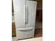Modern white refrigerator with french doors offers ample storage in the kitchen area at 5148 Constitution Ct, Columbus, IN 47203