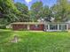 Cozy brick home featuring a spacious backyard with lush greenery, perfect for outdoor entertaining and relaxing at 5240 Southdale Dr, Indianapolis, IN 46217