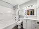 Updated bathroom with tub-shower, modern vanity, and gray walls at 5240 Southdale Dr, Indianapolis, IN 46217