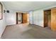 Bedroom featuring mirrored closet doors and two closets at 5240 Southdale Dr, Indianapolis, IN 46217
