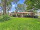Charming brick ranch home with a well-maintained lawn and mature trees at 5240 Southdale Dr, Indianapolis, IN 46217