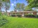 Charming brick ranch home with a well-maintained lawn and mature trees at 5240 Southdale Dr, Indianapolis, IN 46217