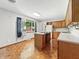 Eat-in kitchen boasts a center island, wood cabinets, neutral countertops, and a window with backyard views at 5240 Southdale Dr, Indianapolis, IN 46217