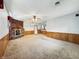 Large living room featuring brick fireplace, neutral walls and a paneled accent at 5240 Southdale Dr, Indianapolis, IN 46217