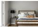 Close up of a bedroom with stylish pillows and rustic nightstand with lamp at 529 E Merrill St, Indianapolis, IN 46203