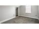 Empty bedroom with neutral carpet and paint, with one window bringing in plenty of light at 529 E Merrill St, Indianapolis, IN 46203