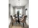 Bright dining room with round table, comfortable chairs, a window, and neutral walls at 529 E Merrill St, Indianapolis, IN 46203