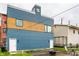 Modern home boasts blue and wood siding, complemented by a stylish exterior and small outdoor patio at 529 E Merrill St, Indianapolis, IN 46203