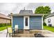 Cozy home exterior features light-blue siding and a door with glass panels, perfect for a starter house at 529 E Merrill St, Indianapolis, IN 46203
