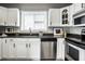 Well-appointed kitchen with stainless steel appliances, white cabinets, and black countertops at 529 E Merrill St, Indianapolis, IN 46203