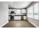 Bright kitchen featuring white cabinets, black countertops, and stainless steel appliances at 529 E Merrill St, Indianapolis, IN 46203