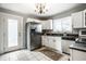 Well-lit kitchen featuring stainless steel appliances, white cabinets, and tiled floors at 529 E Merrill St, Indianapolis, IN 46203