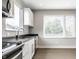 Bright kitchen featuring white cabinets, sleek appliances, and modern countertops at 529 E Merrill St, Indianapolis, IN 46203