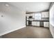 Open-concept kitchen with white cabinets, black countertops, and stainless steel appliances at 529 E Merrill St, Indianapolis, IN 46203