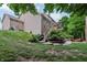 A tiered backyard with a deck, patio, fire pit, established landscaping, and lush green grass at 5441 Ellsworth Dr, Plainfield, IN 46168