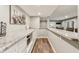 This wet bar has white cabinetry, a granite countertop, stainless steel microwave, and recessed lighting at 5441 Ellsworth Dr, Plainfield, IN 46168