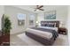Staged bedroom showcasing a king bed, neutral decor, and natural light from the two windows at 5441 Ellsworth Dr, Plainfield, IN 46168