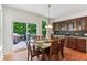 Bright dining area featuring hardwood floors, a deck access and dark wood cabinetry at 5441 Ellsworth Dr, Plainfield, IN 46168