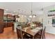 Elegant dining room featuring a stylish table, hardwood floors, and an open view to the kitchen and living area at 5441 Ellsworth Dr, Plainfield, IN 46168