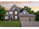 Charming two-story brick home boasting a three-car garage, well-manicured lawn and inviting curb appeal at 5441 Ellsworth Dr, Plainfield, IN 46168