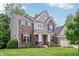 Charming brick two-story home with a manicured lawn and attached two-car garage at 5441 Ellsworth Dr, Plainfield, IN 46168