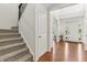Bright foyer featuring hardwood floors, a staircase with iron balusters and an open floor plan at 5441 Ellsworth Dr, Plainfield, IN 46168