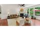 Bright and airy living room with hardwood floors, a cozy fireplace, and large windows at 5441 Ellsworth Dr, Plainfield, IN 46168