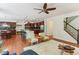 Open-concept living room featuring hardwood floors, fireplace and seamless flow to the kitchen and dining area at 5441 Ellsworth Dr, Plainfield, IN 46168