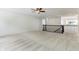 Open loft area boasts neutral carpeting, ceiling fan, and overlooks entry with iron railing at 5441 Ellsworth Dr, Plainfield, IN 46168