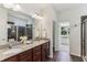 Bathroom featuring double sinks, granite countertops, and a walk-in shower at 5441 Ellsworth Dr, Plainfield, IN 46168