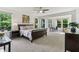 Spacious main bedroom featuring a ceiling fan, neutral carpet, and large window at 5441 Ellsworth Dr, Plainfield, IN 46168