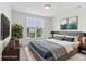This virtually staged bedroom offers soft decor, plush carpeting, and a lovely view through the window at 5441 Ellsworth Dr, Plainfield, IN 46168