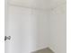 Empty walk-in closet features metal shelves and neutral carpeting and trim at 5441 Ellsworth Dr, Plainfield, IN 46168