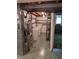 Basement utility area showing laundry hookups, plumbing, ductwork, and shelving for functional storage space at 5807 Sunwood Dr, Indianapolis, IN 46224