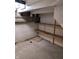 Unfinished basement area featuring shelving and a minimalist aesthetic at 5807 Sunwood Dr, Indianapolis, IN 46224