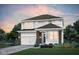 Inviting two-story home with a two-car garage, stylish brick accents, and manicured landscaping at 7151 Stetson Dr, Whitestown, IN 46052