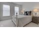 Bright bedroom with a comfy bed, lamps, and natural light streaming through the windows at 729 Greenford N Trl, Carmel, IN 46032