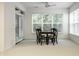 A dining area featuring lots of natural light and a black dining table with four chairs at 729 Greenford N Trl, Carmel, IN 46032