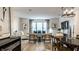 Open concept living room and dining area with hardwood floors, white furniture and natural light at 729 Greenford N Trl, Carmel, IN 46032