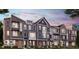 Modern townhome exteriors featuring brick and siding accents, multiple stories, and well-manicured landscaping at 7333 Bayview Run, McCordsville, IN 46055