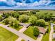Aerial view of the neighborhood with the property, green lawns, and mature trees at 7405 N Janna Dr, Muncie, IN 47303