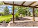 Covered backyard patio looking out onto a professionally landscaped backyard at 7405 N Janna Dr, Muncie, IN 47303