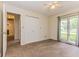 Bedroom features carpeted floor, large window with view to back yard, and ceiling fan at 7405 N Janna Dr, Muncie, IN 47303