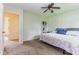 Cozy bedroom featuring a ceiling fan, plush carpeting, and ample natural light at 7405 N Janna Dr, Muncie, IN 47303