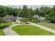 Aerial view of a property with well-maintained lawns, mature trees, and a circular driveway at 7554 Silverpine Ct, Indianapolis, IN 46250