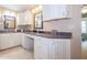 Bathroom vanity featuring granite countertops, ample cabinet space, dual mirrors, and great lighting at 7554 Silverpine Ct, Indianapolis, IN 46250