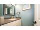 Stylish powder room features modern fixtures, framed art and mirror, granite countertop, and neutral walls at 7554 Silverpine Ct, Indianapolis, IN 46250