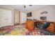 Bedroom with a colorful rug, desk, chair, television, and motorcycle art at 7554 Silverpine Ct, Indianapolis, IN 46250